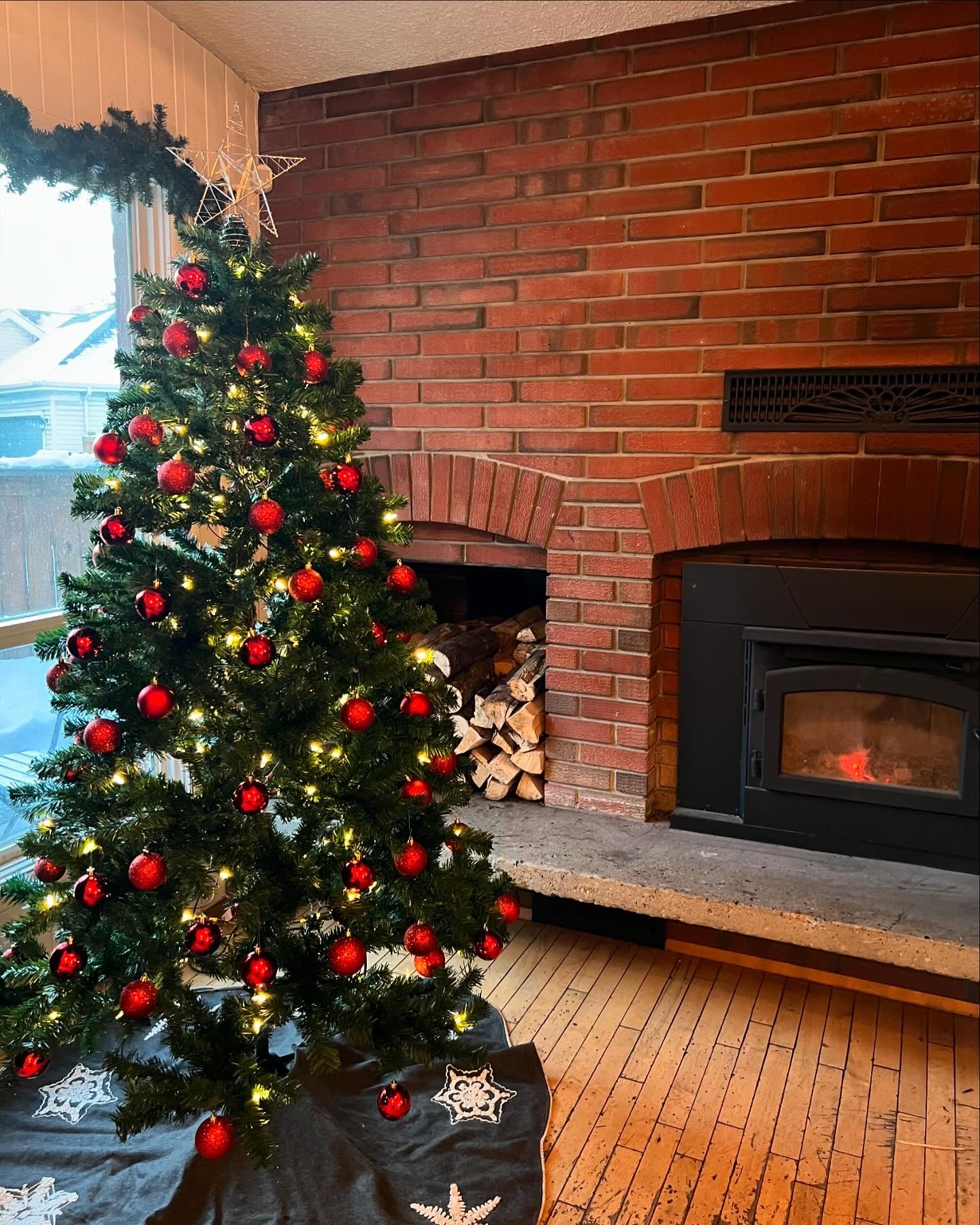 The fireplace inside Little Brick, with a tree beside it