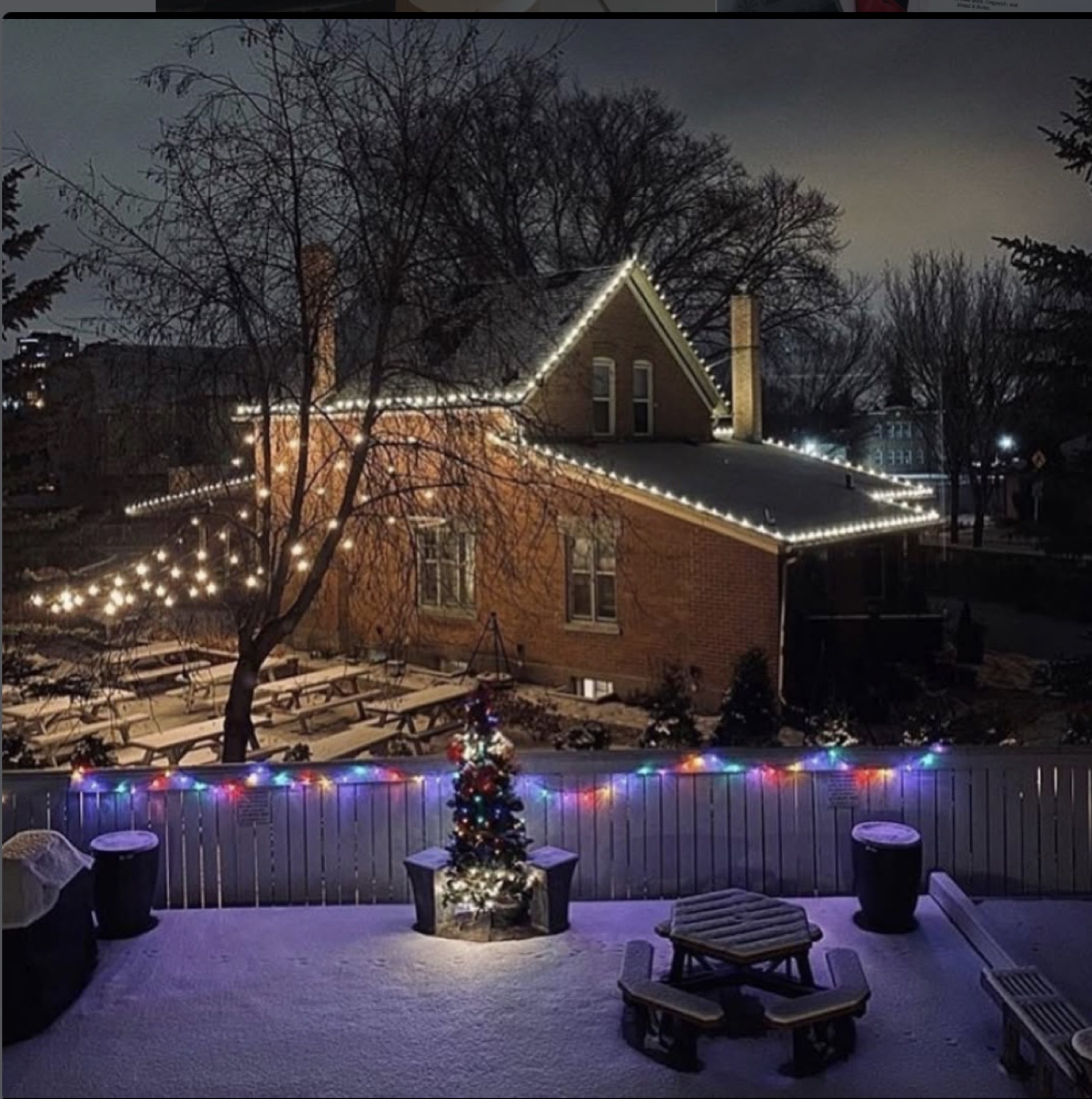 The Little Brick house lit up at night